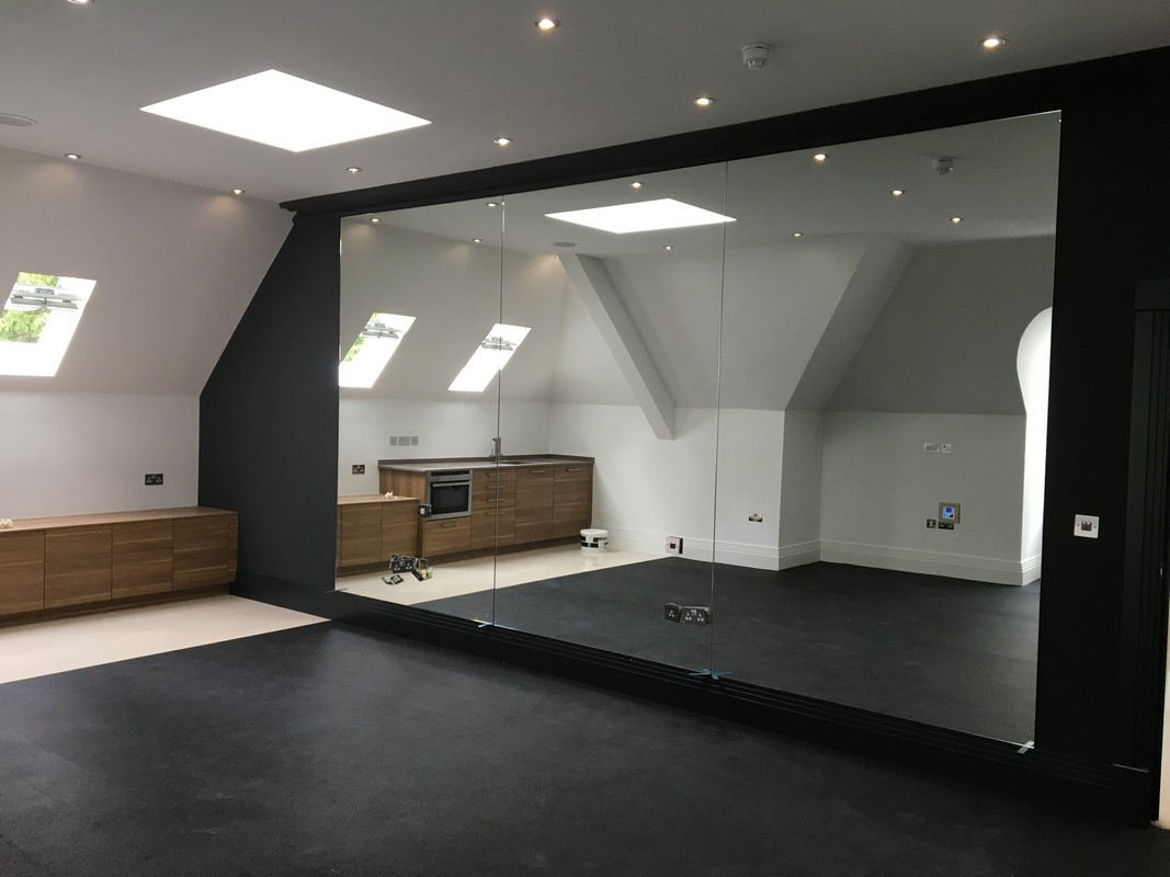 Frameless glass wall dividing loft conversion in Clapham Junction